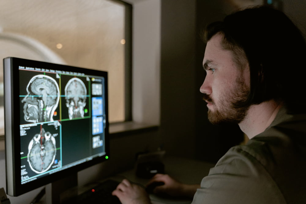 Scientist looking at MRI brain scan.