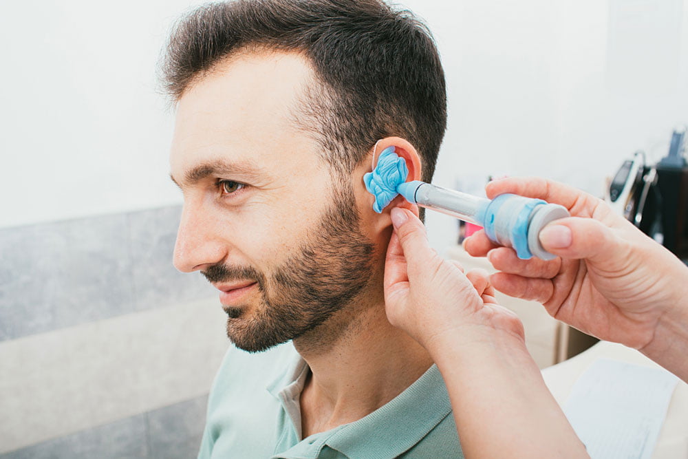 Middle-aged having his ear moulds taken